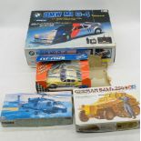 Two boxed radio control BWM M1 cars (one missing power cable), along with two boxed military plastic