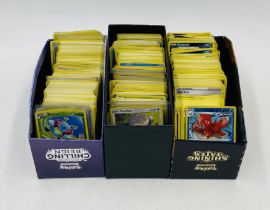 A collection of Pokemon cards from various sets including some holograms etc