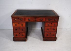 A Victorian mahogany kneehole desk, with nine drawers with turned handles - some attention