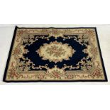A large Chinese rug with floral detail - 230cm x 170cm
