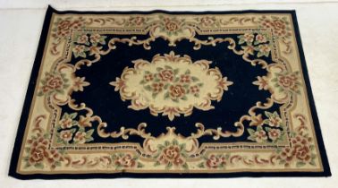 A large Chinese rug with floral detail - 230cm x 170cm