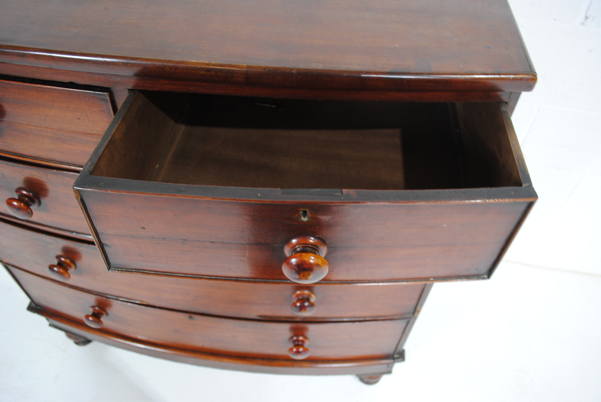 A Victorian mahogany bow-fronted chest of five drawers, raised on turned legs - one leg loose but - Image 5 of 8