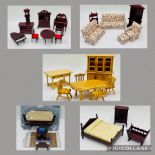 A collection of dolls house furniture including a floral three-piece suite, dining table and chairs,