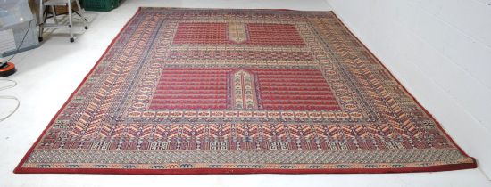 An Eastern style red ground carpet. some fraying to one edge 366cm x 277cm, 12ft x 9ft
