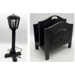 A small wooden lamp on carved base along with a carved wooden magazine rack