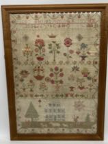 A large antique undated sampler initialled C.A depicting a house, animals flowers etc. 61cm x 42cm
