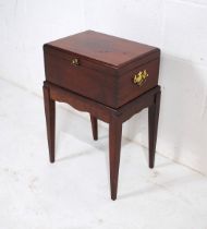 A small mahogany box on stand, with brass handles - height 54cm
