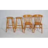 A pair of pine stools, along with a pair of modern country chairs