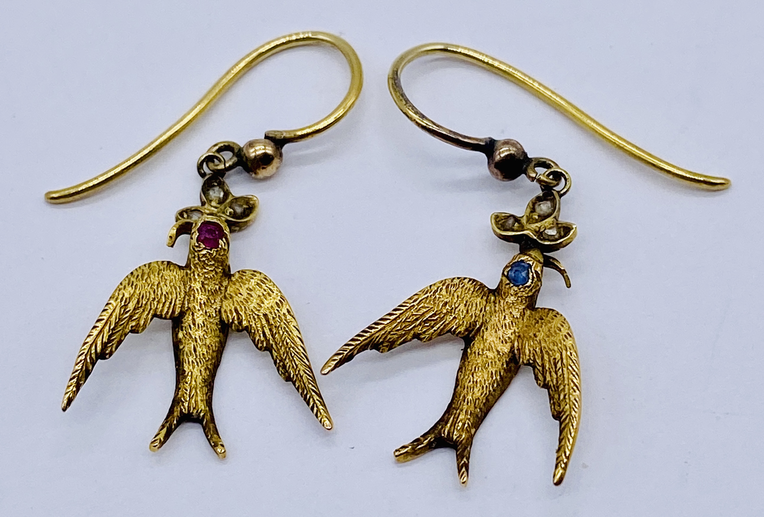 A pair of 15ct gold earrings in the form of swallows, each set with diamonds, total weight 3.1g