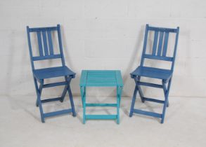 A pair of folding blue painted garden chairs, named to 'Bantham Beach', along with a small folding