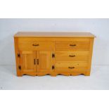 A modern pitch pine sideboard, with four drawers and cupboard - length 145cm, depth 40cm, height