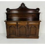 A Victorian style mahogany chiffonier with scrolling raised panel above three drawers and cupboard