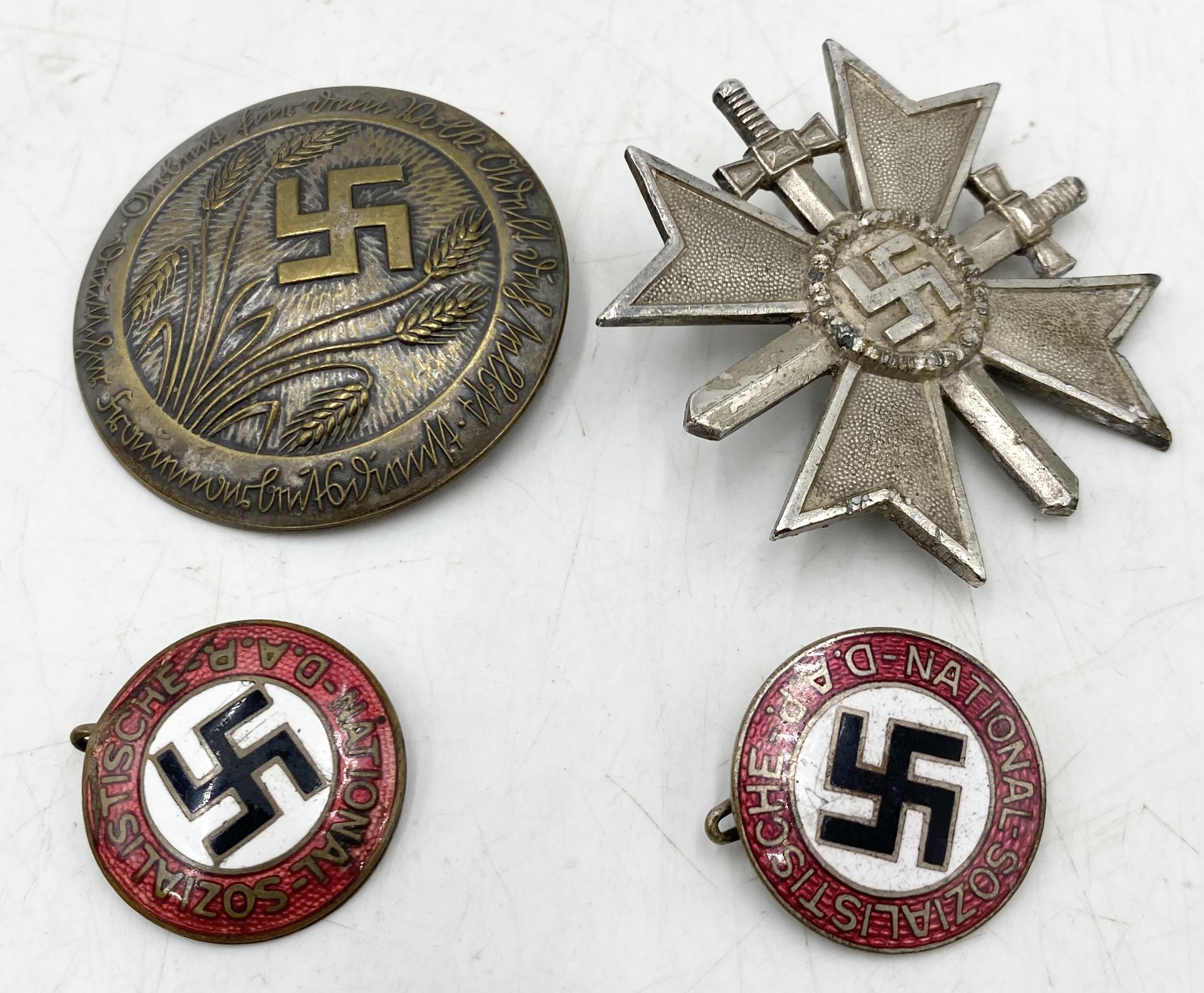 Two WWII German NSDAP party badges, a War Merit Cross 1939 (marked L15) along with a Third Reich