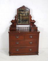 A Victorian mahogany dressing chest of four drawers, with carved detailing and bevel edged glass