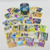 A small collection of modern Pokemon card, stored in a Pokemon tin