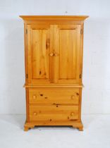A modern pine linen press, with two drawers under - length 94.5cm, depth 52cm, height 171.5cm