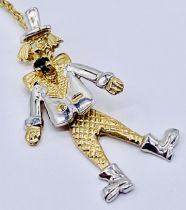 A 9ct gold articulated clown pendant on a fine 9ct gold chain, total weight 2.4g