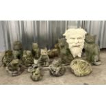 A collection of garden ornaments and animals including green man, frogs, cats, dogs etc.