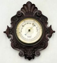 An antique barometer in carved mahogany case by Chadburns Ltd, Liverpool.