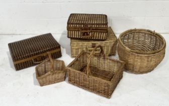 A collection of wicker baskets, picnic baskets, woven bamboo suitcase