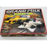 A vintage boxed Grand Prix Scalextric set (looks complete), along with a box of Scalextric