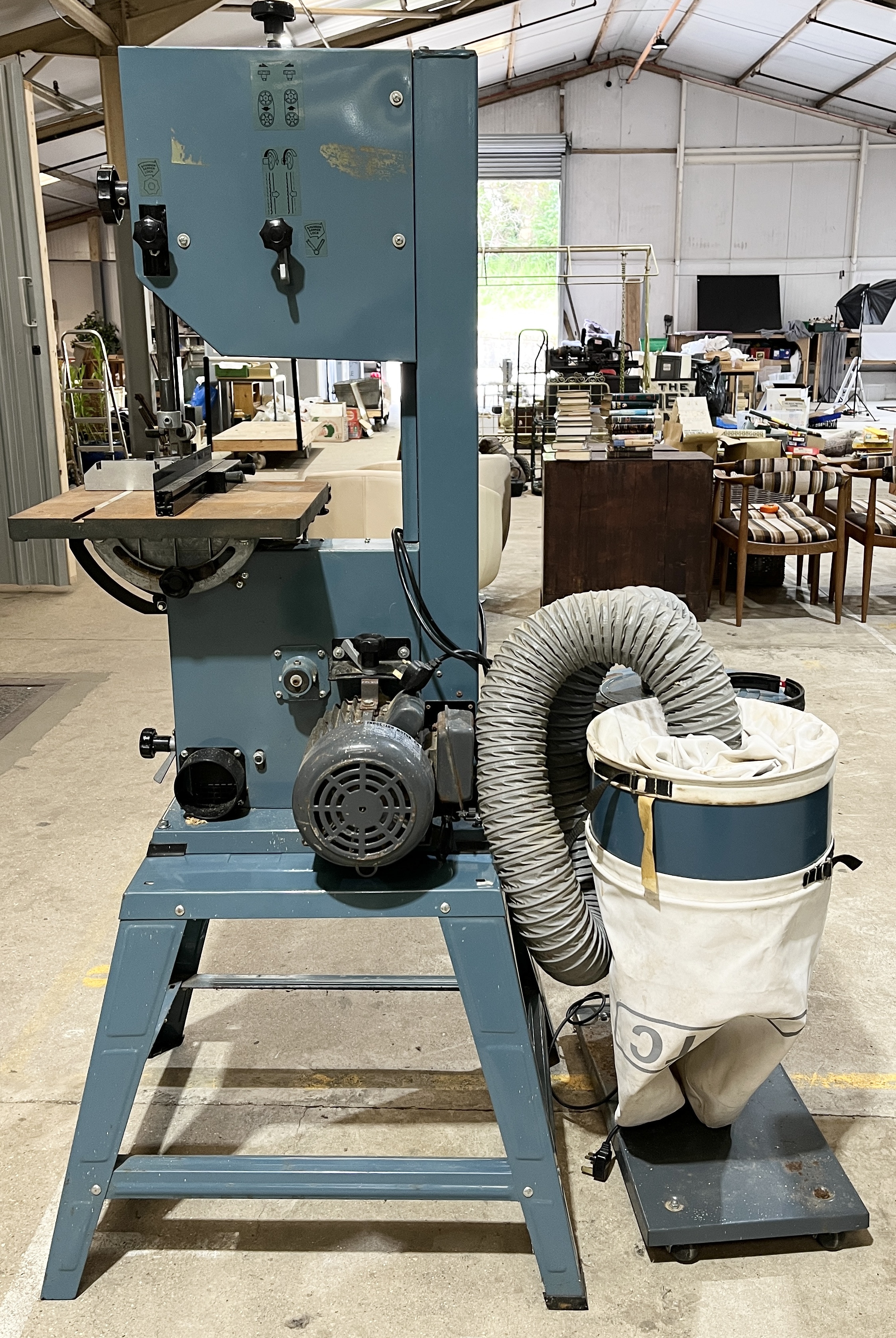 An Axminster Power Tools floorstanding band saw along with a dust extractor