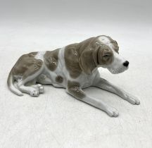 A continental figurine of a dog, possibly a Fox Hound, 22cm length