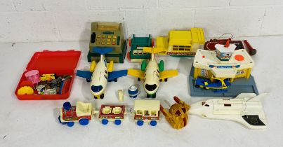 A collection of vintage Fisher Price toys including planes, train, cash till, boat, space shuttle,