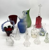 A collection of various glass including large cranberry bell, art glass vases etc.
