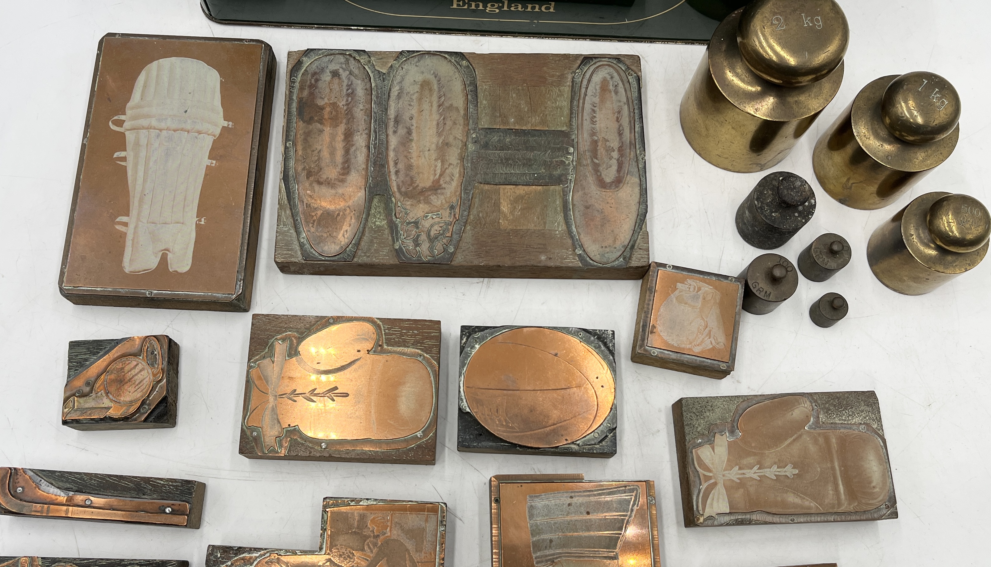 A collection of weights and vintage printing blocks mainly on the theme of sport - Image 2 of 3