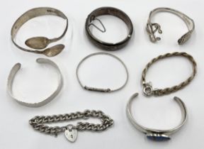 A collection of 925 and hallmarked silver bracelets and bangles
