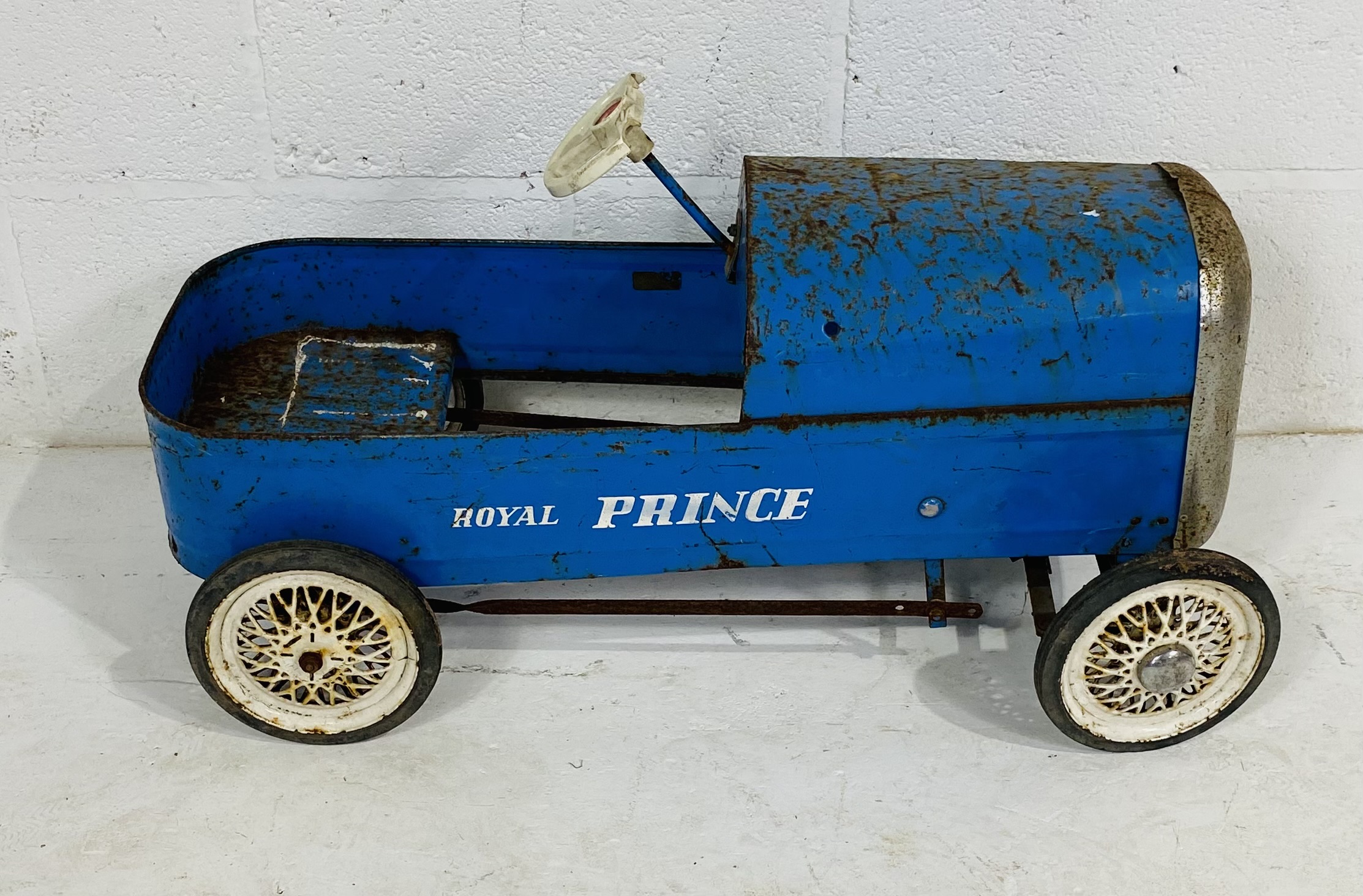 A vintage Tri-ang child's 1960s pedal car in blue, marked 'Royal Prince' to the side - steering