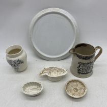 A small collection of turn of the century pottery including blancmange moulds, God Speed the