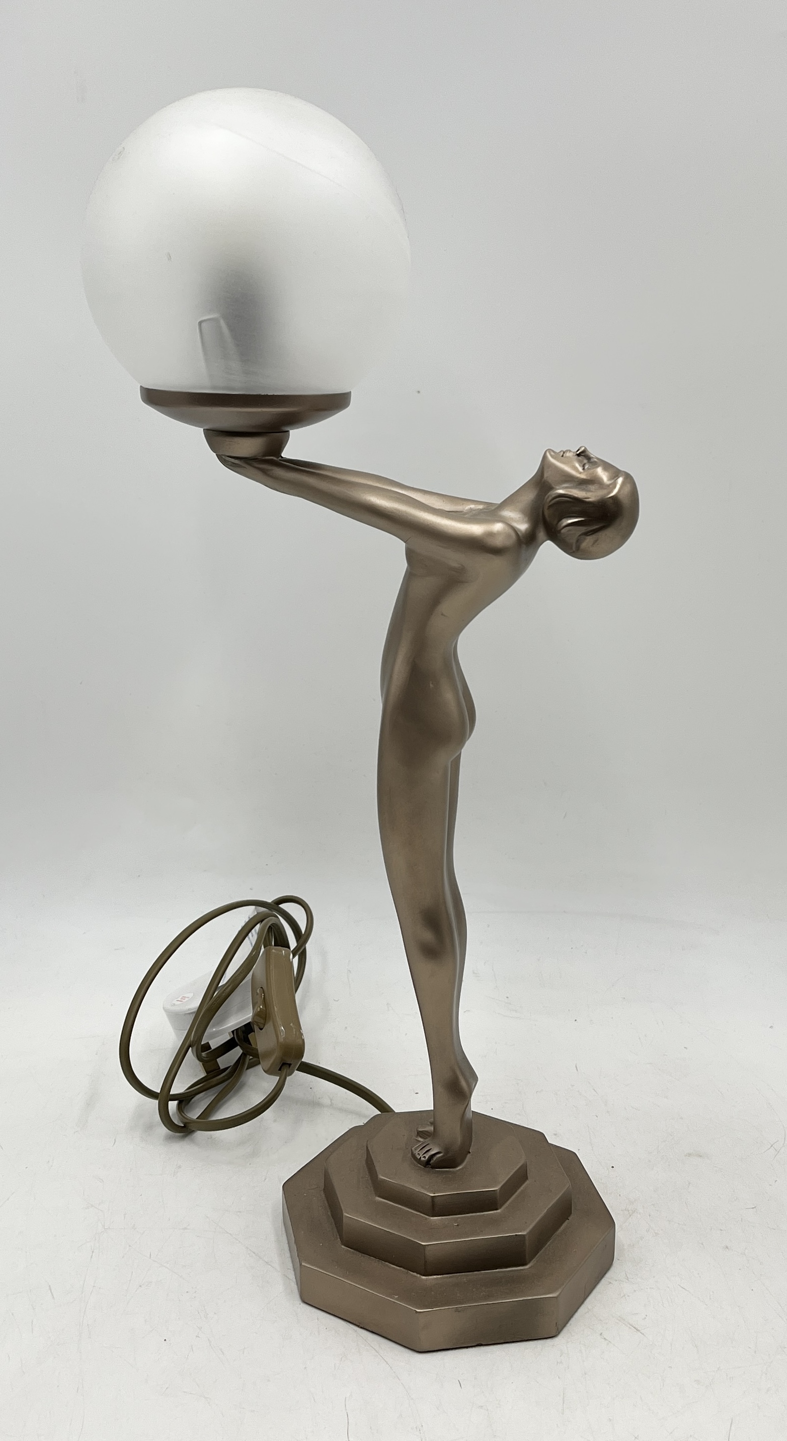 An Art Deco style table lamp in the form of a nude female holding a globe - Overall height 50cm