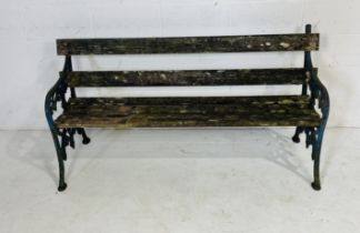 A weathered garden bench with cast iron ends (one with small amount of damage as shown) 161cm x