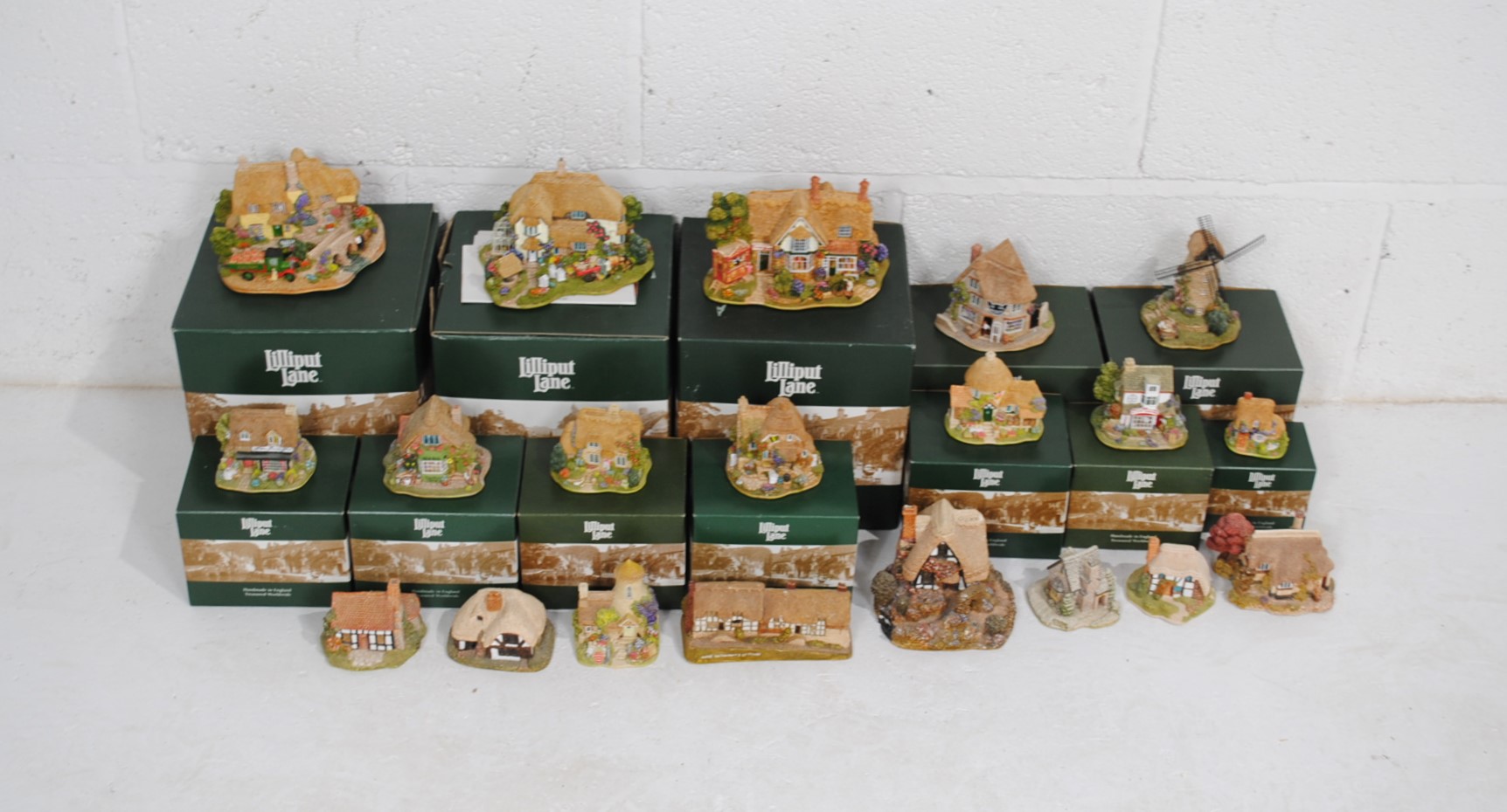 A collection of Lilliput Lane models, including some boxed, over two shelves
