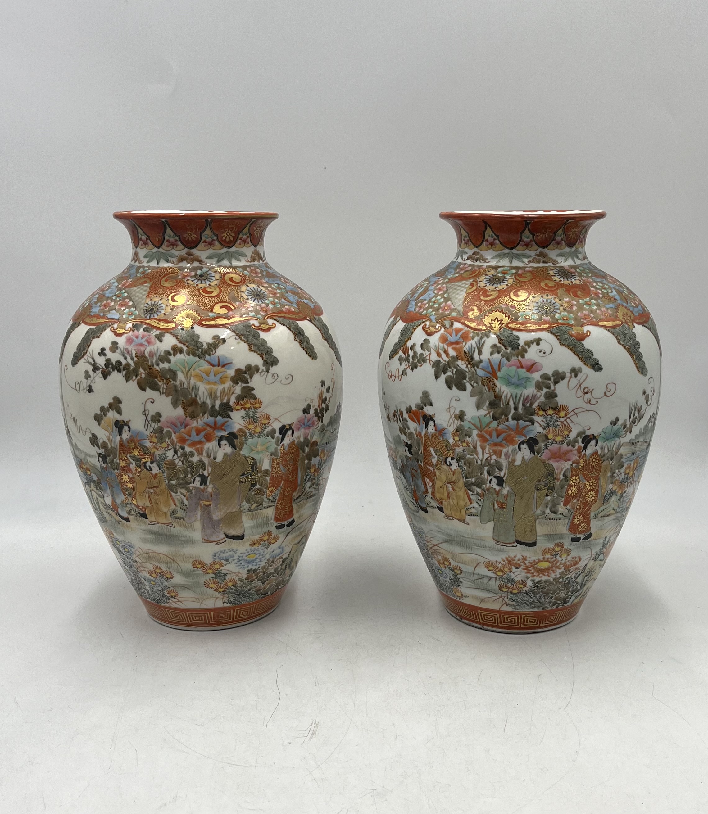 A pair of Japanese Kutani ware vases with six-character marks to base. Approximate height 30cm