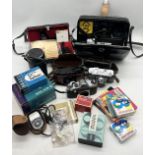 A collection of various vintage cameras and video cameras with accessories including Canon Super