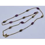 A 9ct gold necklace interspersed with amethyst coloured beads, weight 3.5g