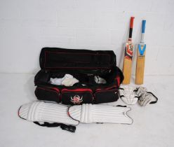 A collection of right handed cricketers gear, including two bats (one Kookaburra and one Slazenger),