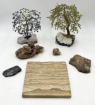 A collection of mineral and fossil specimens including fossilised wood, "Desert Rose" gypsum,