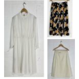 A collection of vintage Delmod clothing including pleated skirt, white summer dress and cream skirt