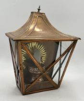 A copper framed lantern with cross banded detail