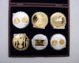 A cased set of six oversized coins, including Concorde, Liberty, Nefertiti etc, all with