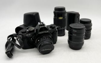 A Pentax K2 camera with three additional lenses