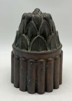 A large antique copper jelly mould - height approx. 24cm