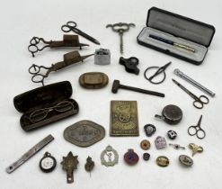 A collection of various items including military cap badges, silver Warwickshire regiment button,