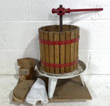 A vintage apple press with blocks mounted on board.