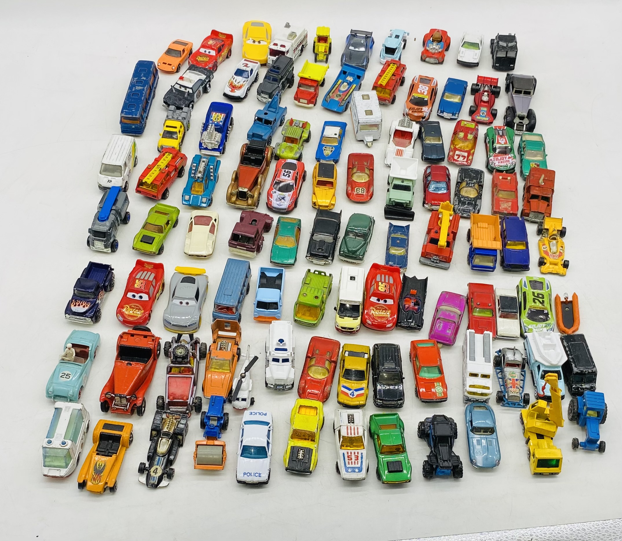 A collection of playworn die-cast vehicles including Matchbox, Mattel Disney Pixar, Oxford,