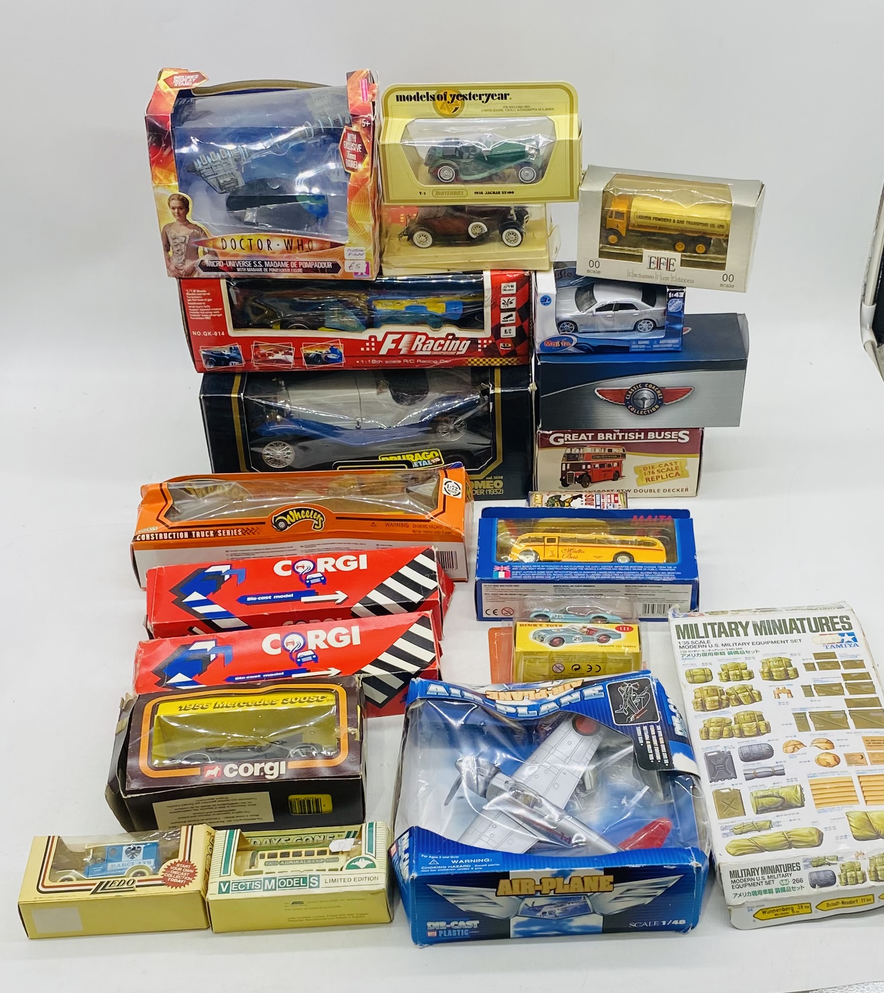 A collection of various boxed die-cast vehicles including Burago Alfa Romeo, Altas Edition Great
